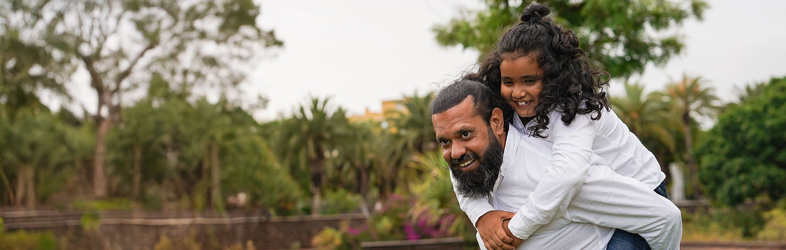 Man lifting a child on his back.