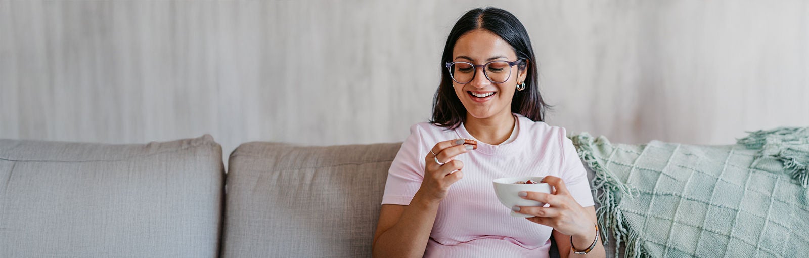 Woman looking at a cookie in her hand
