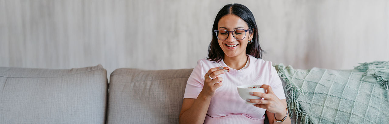 Woman looking at a cookie in her hand