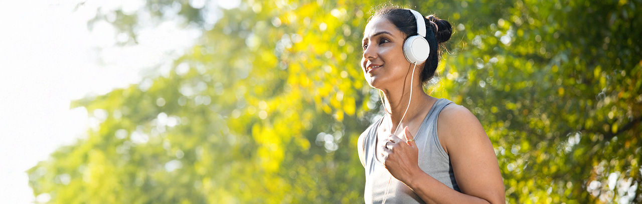Woman jogging wearing headphones.